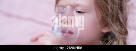 Little girl making inhalation of hormonal drug using nebulizer Stock Photo
