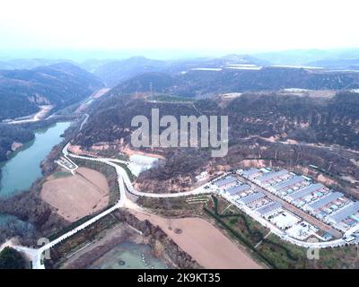 (221029) -- XI'AN, Oct. 29, 2022 (Xinhua) -- This aerial photo taken on Oct. 26, 2022 shows a view of Nangou Village of Yan'an, northwest China's Shaanxi Province. Covering an area of 24 square kilometers, the Nangou Village is home to more than 1,000 villagers. Led by the village's Party branch, Nangou has worked out ways to inject vitality into the countryside. It has witnessed the boom of planting and breeding industries and rural tourism. Villagers have constantly increased their income by earning dividends and taking odd jobs during the slack farming season. (Xinhua/Zhang Bowen) Stock Photo