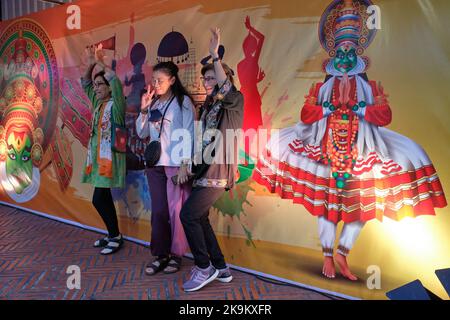 During Diwali festivities at Ong Ang Walking Street in Pahurat, Bangkok, Thailand, young Thais pose in front of an Indian-themed background Stock Photo
