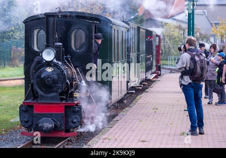 29 October 2022, Mecklenburg-Western Pomerania, Klütz: The small steam locomotive with 20 hp of the company Orenstein&Koppel from the year of construction 1921 is coupled in front of a passenger train in the station and prepared for a trip on the small railway line 'Kaffeebrenner'. For the end of the season on the tourist railroad with a track width of 600 millimeters, the route is traveled by a historic steam steed. The train will reach a speed of 20 kilometers per hour on the just six-kilometer route between Klütz and Reppenhagen. The railroad line in northwest Mecklenburg was opened on June Stock Photo