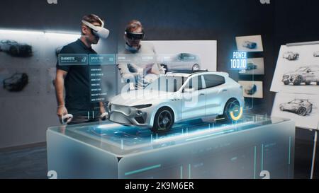 Two development engineers in the studio are designing an eco-friendly sustainable standard electric vehicle using 3D modeling technology and VR headsset. 3D interface of diagnostic application. Stock Photo