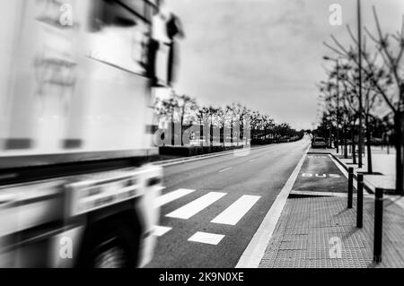 Blurred truck in the foreground with a road in front Stock Photo