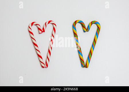 christmas lollipops on a white background. candy hearts rainbow and white red Stock Photo