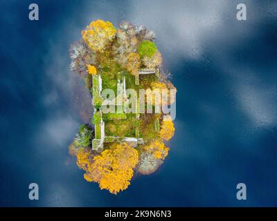 Aviemore, Scotland, UK. 29th October 2022.  Aerial view of spectacular late autumn colours and reflections of clouds  around ruined castle on island on Loch an Eilein in the Rothiemurchus estate in Cairngorms National Park near Aviemore in Scottish Highlands.  Iain Masterton/Alamy Live News Stock Photo