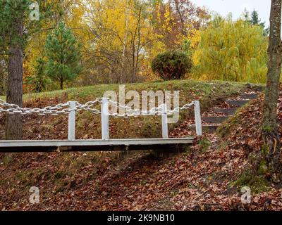 Iron bridge over a dried up lake to the steps going up Stock Photo