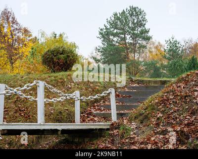 Iron bridge with handrails made of chains to the steps going up Stock Photo
