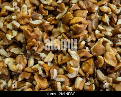Peeled Georgian nuts. Background of nuts without shells. Snack on the table. Squirrel food. Lots of nuts. Hearty ingredient. Tasty food. Market stall. Stock Photo