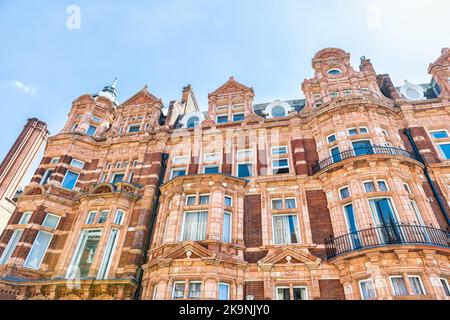 Apartment flats house building in Gothic revival style architecture in Mayfair, Westminster of London UK by Park lane street road near Hyde park Stock Photo