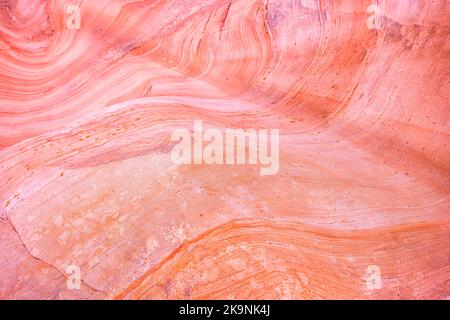 Macro closeup abstract red pink colorful sandstone rock formation layers of wave pattern on rock cliff in Gifford Canyon trail Utah Zion National Park Stock Photo