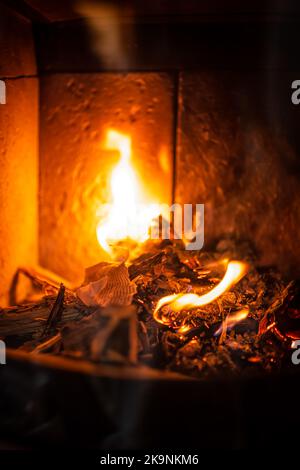 Burning paper, letters in indoor home interior fireplace in fire flames in traditional house furnace stove Stock Photo