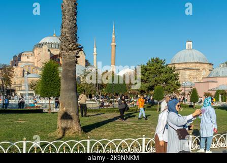 Turkish women taking selfie in Sultan Ahmet Parki with view of landmarks. Turkey woman doing selfies. Fatih, Istanbul, Turkey Stock Photo