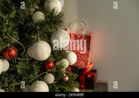 Beautiful Christmas gifts under fir tree on floor in room Stock Photo