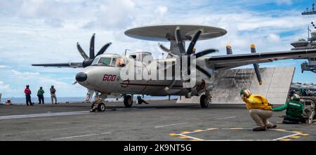 Northrop Grumman E-2 Hawkeye is an American all-weather, carrier-capable tactical airborne early warning (AEW) aircraft. Capt. Fred Goldhammer, commanding officer of the U.S. Navy’s only forward-deployed aircraft carrier USS Ronald Reagan (CVN 76), launches from the flight deck in an E-2D Hawkeye attached to the Tigertails of Airborne Early Warning Squadron (VAW) 125 Stock Photo