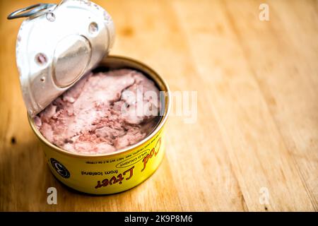 Herndon, USA - December 20, 2020: Storebought traditional canned cod liver in oil in can with open lid, wild caught in Iceland on kitchen table Stock Photo