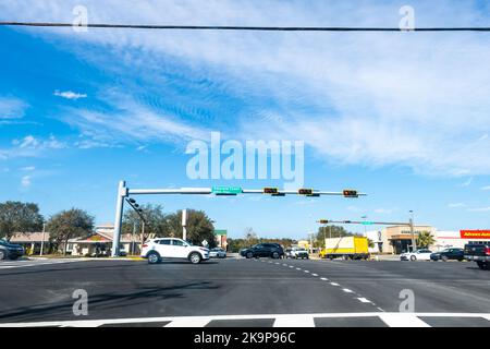 Destin, USA - January 13, 2021: Okaloosa county beach city, Florida panhandle with Emerald coast US highway road 98 with cars traffic stoplight light Stock Photo