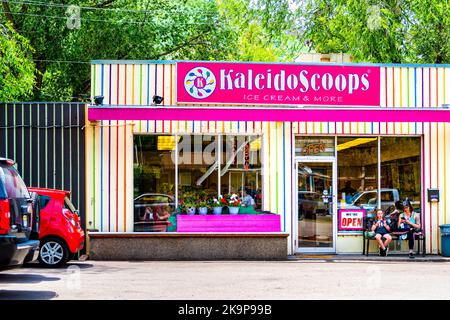 Glenwood Springs, USA - June 29, 2019: People family sitting eating at ice cream store shop parlor Kaleidoscoops in Colorad downtown city town Stock Photo