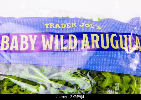 Naples, USA - October 21, 2021: Closeup macro sign for Trader Joe's private label brand of wild baby arugula salad raw green fresh in plastic bag Stock Photo