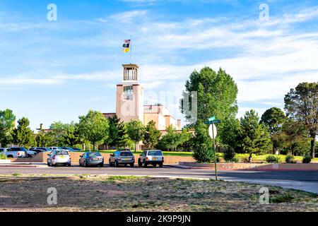 Santa Fe, USA - June 14, 2019: Capitol government building center for Veteran services in downtown center of city with green park and flags Stock Photo