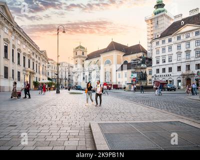 Vienna, Austria - June 2022: Scene from Historisches Zentrum von Wien ( Historic city center in Vienna). Tourists on the cobblestone streets of Vienna Stock Photo