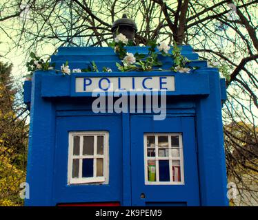 Tardis blue police telephone box with flower garland Stock Photo