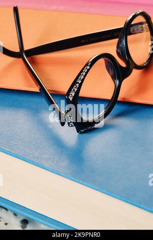 Still life of eyeglasses on bound books, United States 2022 Stock Photo