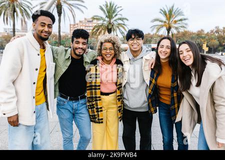 Group portrait of multi-ethnic young best friends smiling at camera in Barcelona Stock Photo