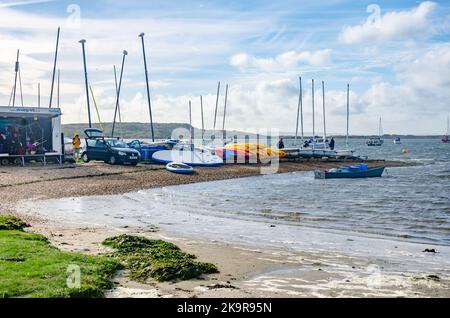 Boats stored on land next to the sea at Mudeford near Christchurch in Dorset, UK Stock Photo