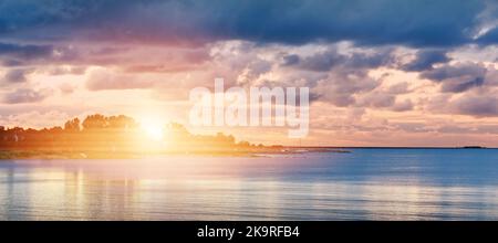 Soft sunset over ocean. sunset in cloudy day over baltic sea. Stock Photo