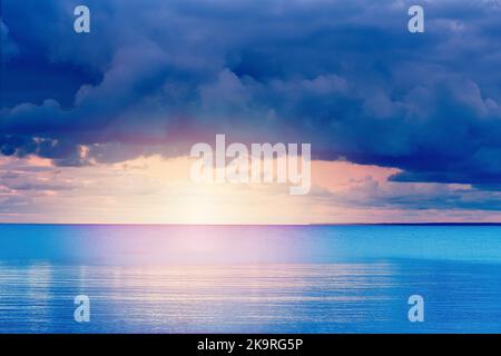 Soft sunset over ocean. sunset in cloudy day over baltic sea. Stock Photo