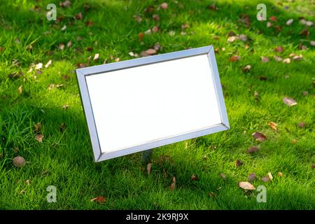 Ad billboard standing in a field of grass Stock Photo