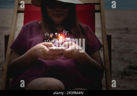Startup business with icon business and network connection on modern virtual interface from digital smartphone. Young woman touching on mobile phone s Stock Photo