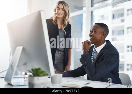 Working together to transform the face of business. two businesspeople working together in an office. Stock Photo