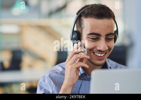 Our friendly operators are waiting for your call. a young call centre agent working in an office. Stock Photo