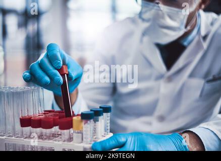 This is not simple, it takes skill. an unrecognizable male scientist working in a lab. Stock Photo