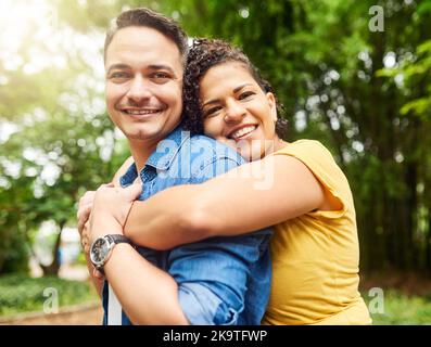 Ill never let him go. Cropped portrait of an affectionate young couple enjoying their day in the park. Stock Photo