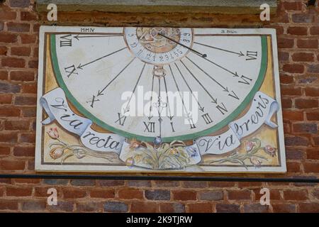 Pralormo, Italy, May 2022 Beautiful sundial painted on the wall of the city castle. Stock Photo