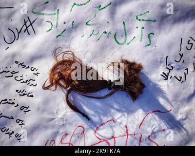 Munich, Bavaria, Germany. 30th Oct, 2022. To he hair of an Iranian protester in Munich, Germany. Iranians of the City of Munich, Germany demonstrated for the rights of women in Iran who are demanding equality in the wake of the death of Jina Mahsa Amini and numerous others killed by regime forces in the subsequent protests. The first protests began after the funeral of Amini in the city of Saqqez as women began removing their hijabs and later began cutting their hair inspiring protests worldwide often under the banner of Ã¢â‚¬Å“Women, Life, FreedomÃ¢â‚¬Â and Ã¢â‚¬Å“Death to the DictatorÃ¢â Stock Photo