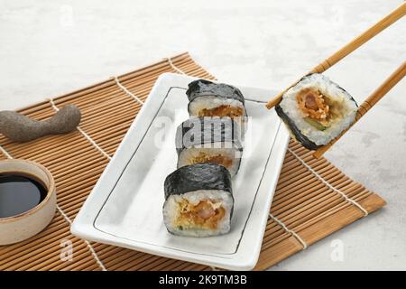 Sushi Rolls with nori served on white plate. Stock Photo