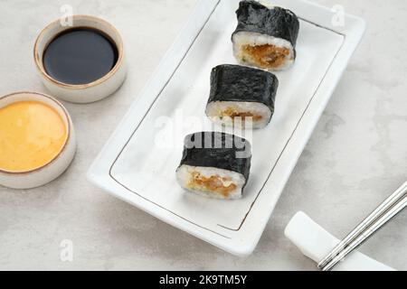 Sushi Rolls with nori served on white plate. Stock Photo
