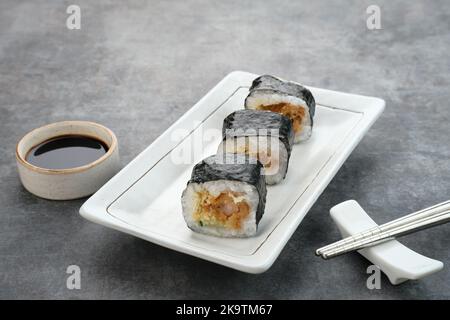 Sushi Rolls with nori served on white plate. Stock Photo