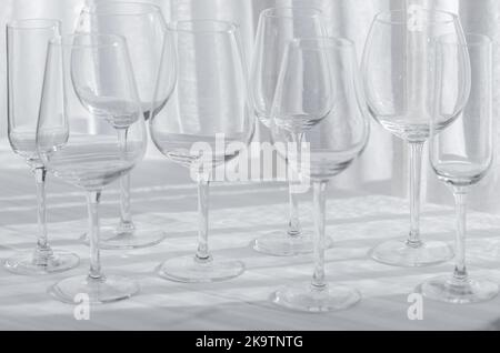 Several glasses for different kind of wine on the white tablecloth. Stock Photo