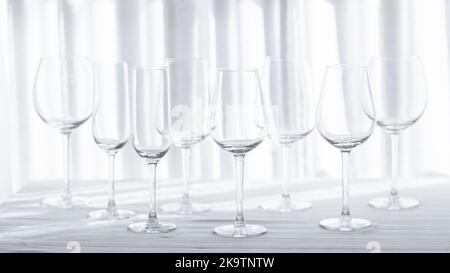 Several glasses for different kind of wine on the white tablecloth. Stock Photo