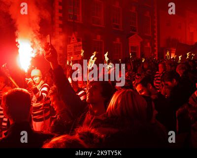 A celebrant captures events on his mobile phone camera at the Lewes Bonfire Night Celebrations of 2014 Stock Photo