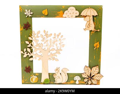rectangular wooden frame decorated with colorful autumn leaves on a white background, space for text wooden frame decorated Stock Photo