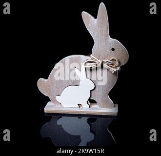 Beautiful wooden toy rabbit. Old hand-made souvenirs wooden toy rabbit isolated on black Stock Photo