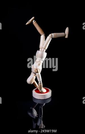 Image of falling wooden manikin on black background, wooden manikin poses different posing Stock Photo