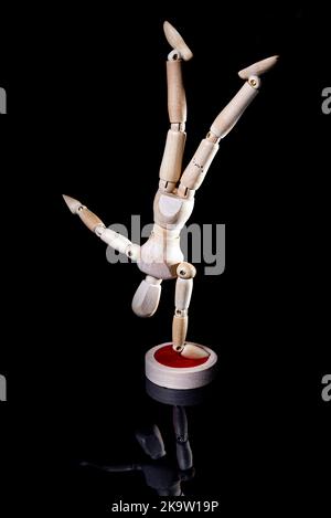 Image of falling wooden manikin on black background, wooden manikin poses different posing Stock Photo