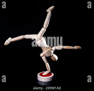 Image of falling wooden manikin on black background, wooden manikin poses different posing Stock Photo