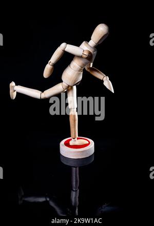 Image of falling wooden manikin on black background, wooden manikin poses different posing Stock Photo