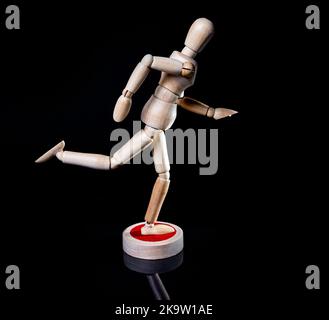 Image of falling wooden manikin on black background, wooden manikin poses different posing Stock Photo